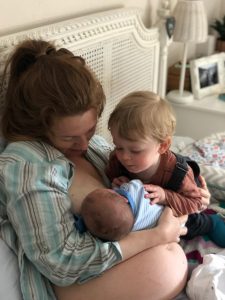 Jess with her toddler and breastfeeding her newborn baby